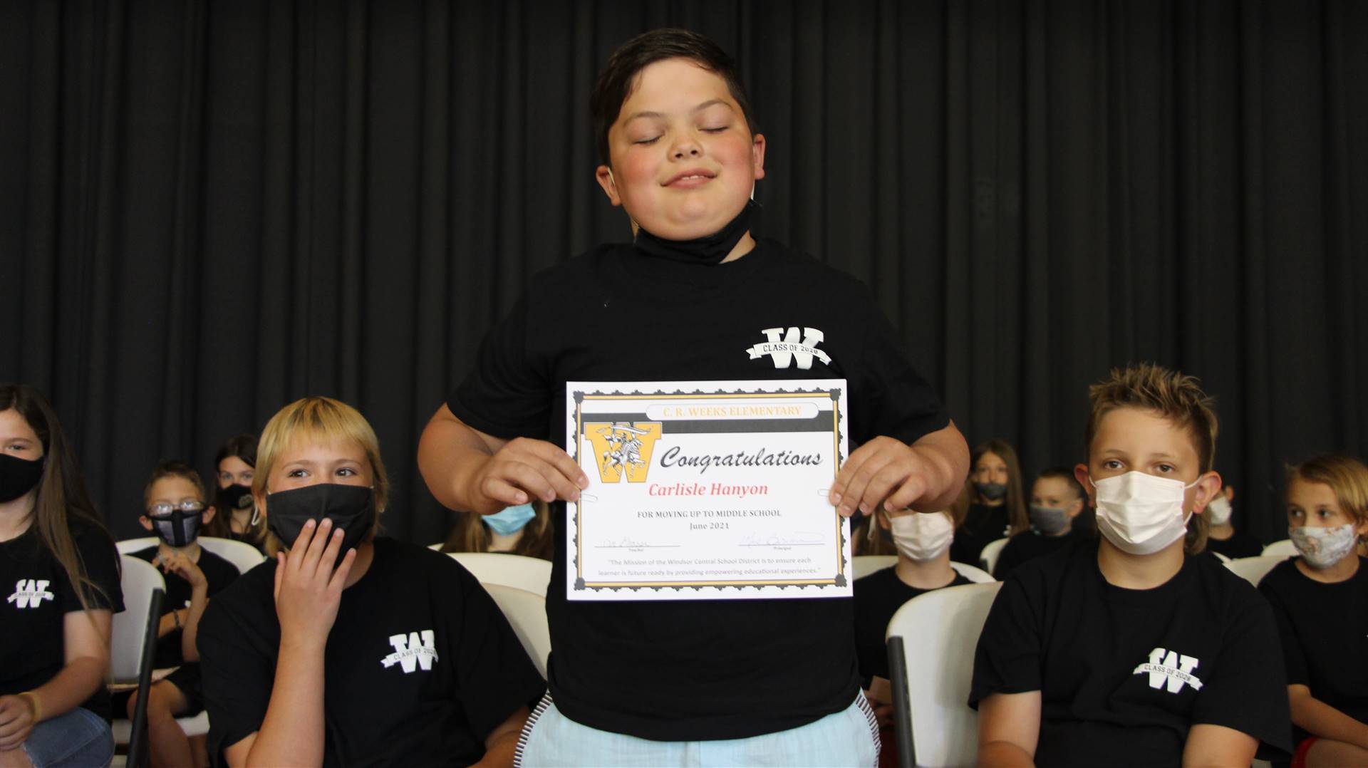 Young boy holding a certificate