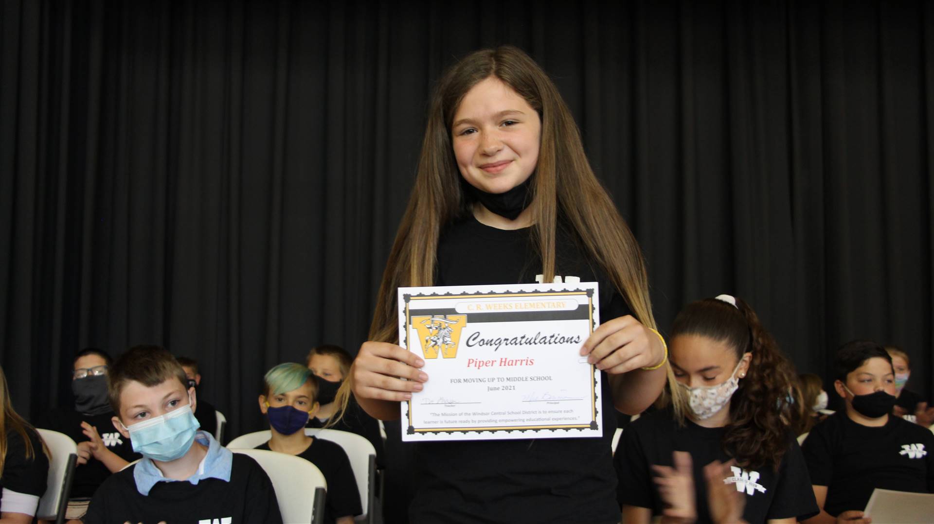 Young girl holding a certificate