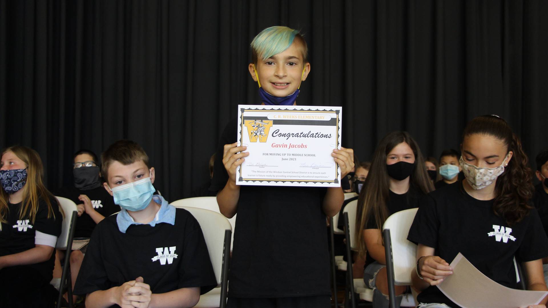 Young boy holding a certificate