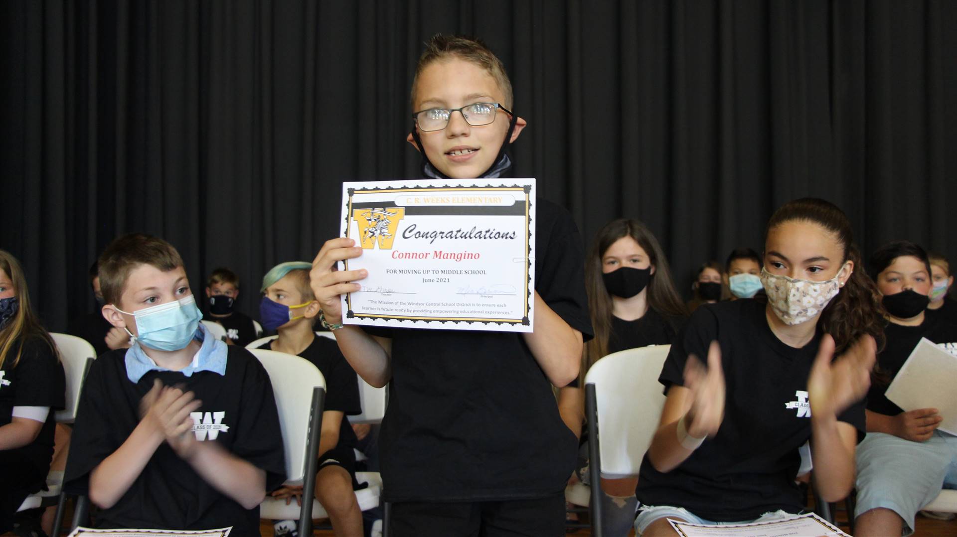 Young boy holding a certificate