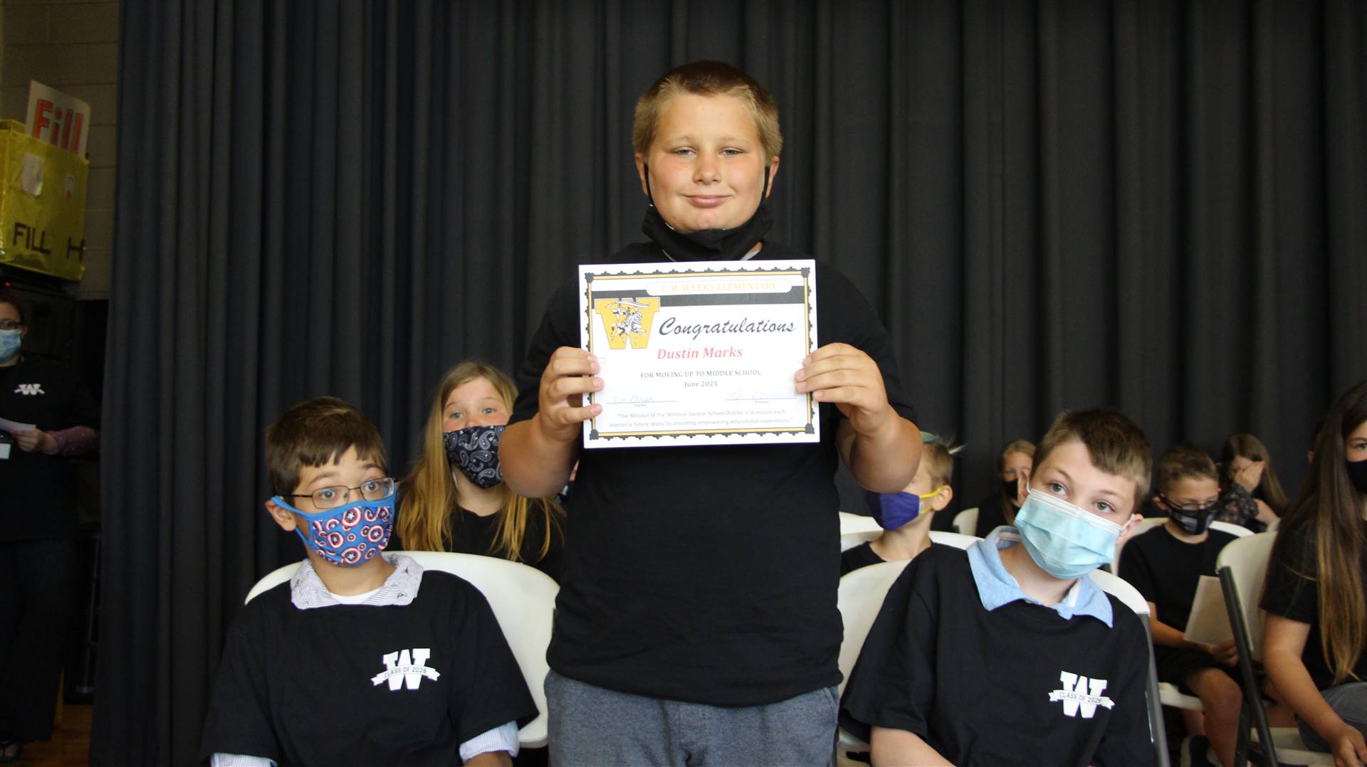 Young boy holding a certificate