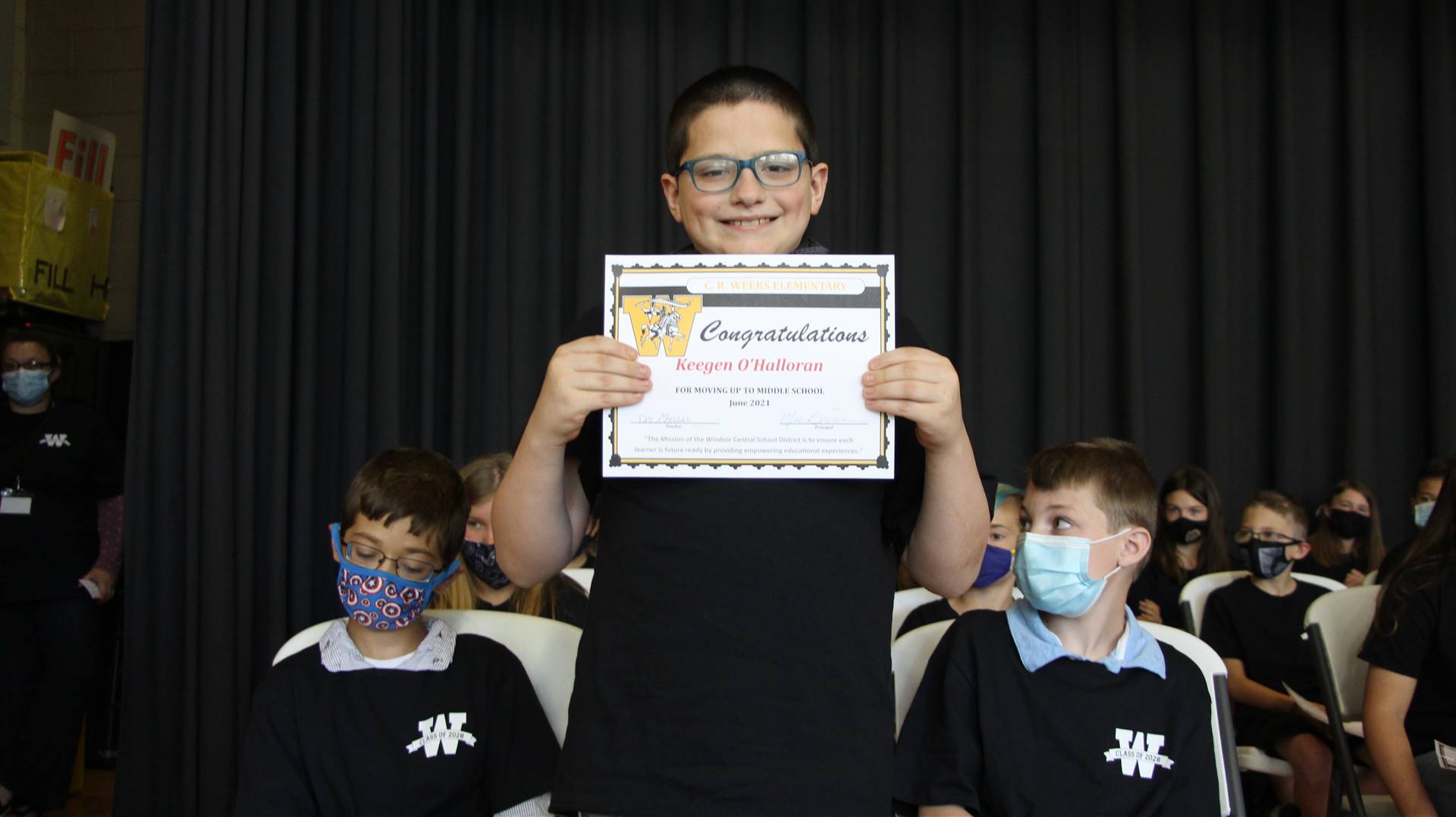 Young boy holding a certificate