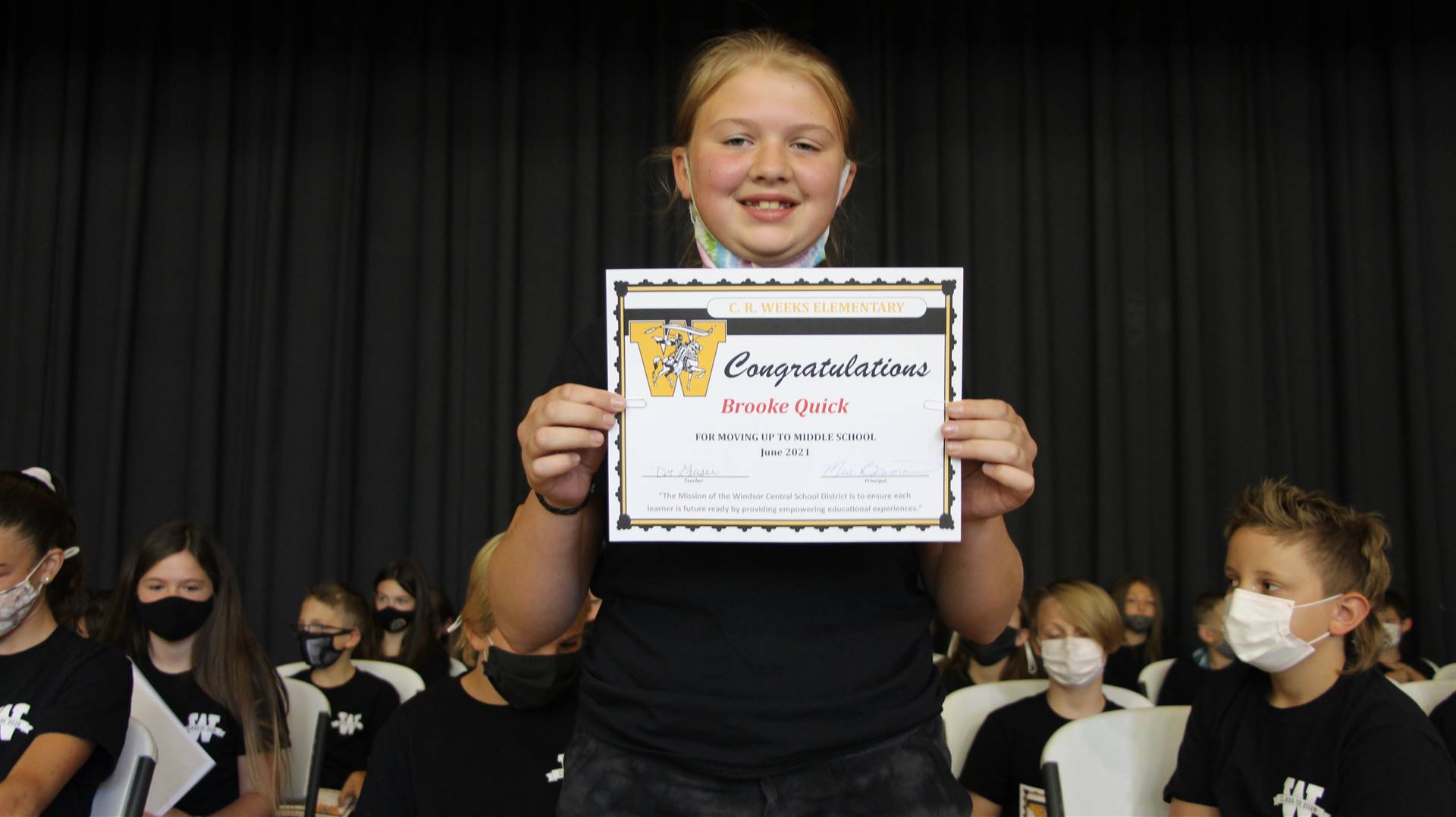 Young student holding a certificate