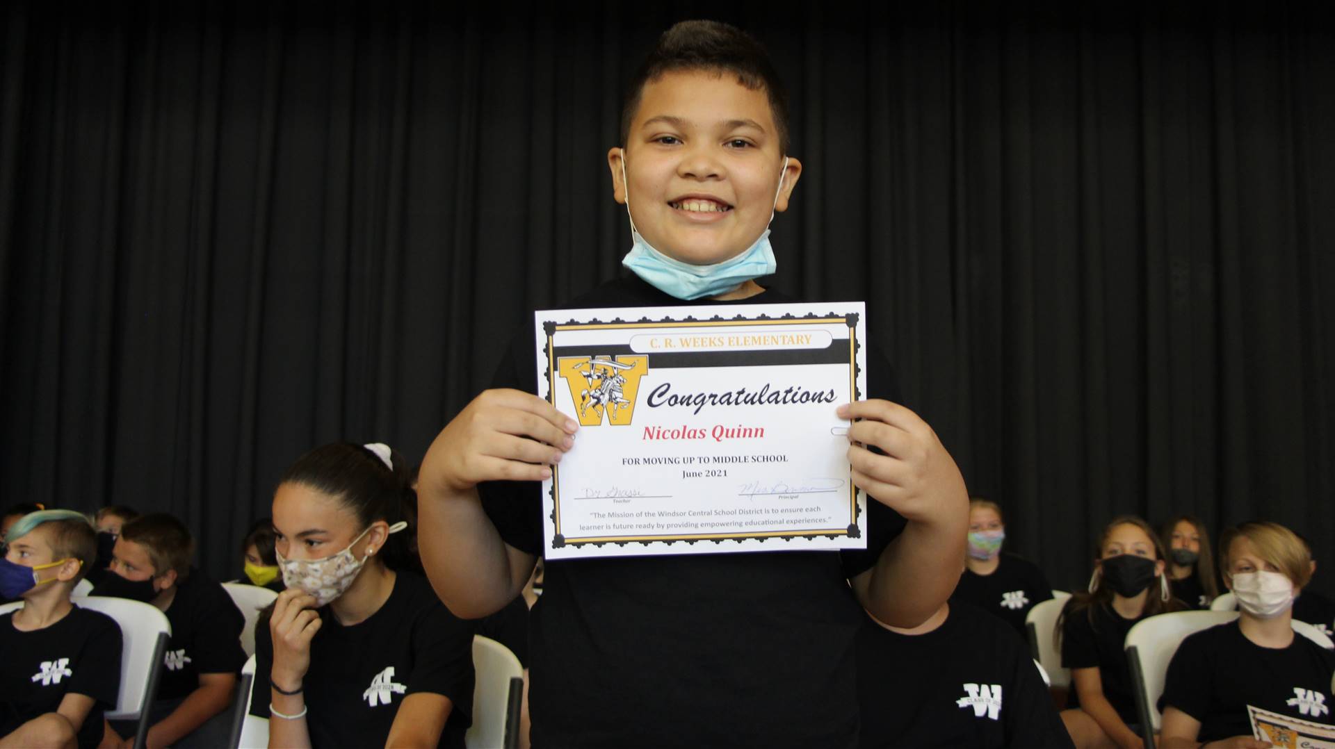 Young boy holding a certificate