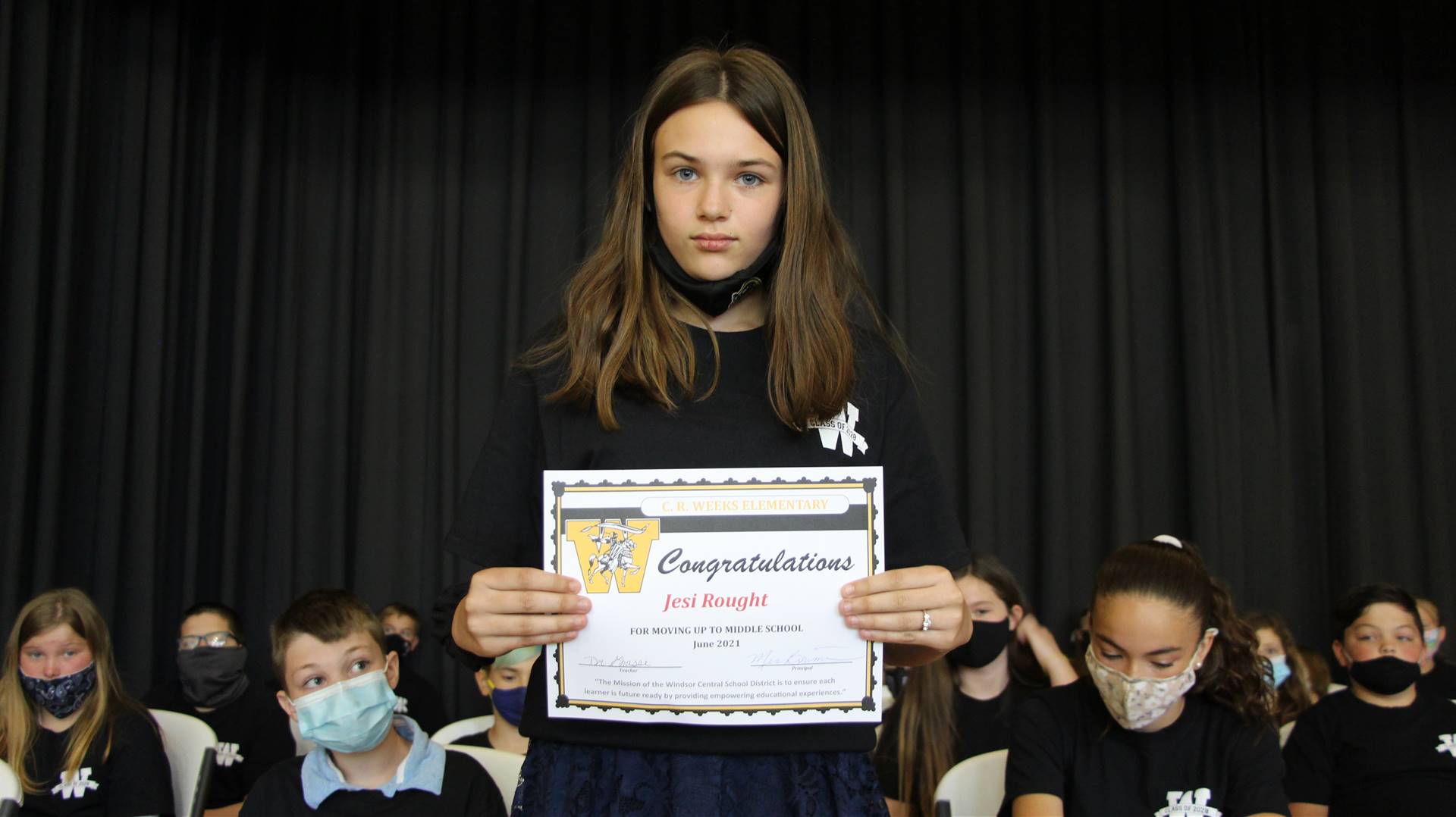 Young girl holding a certificate