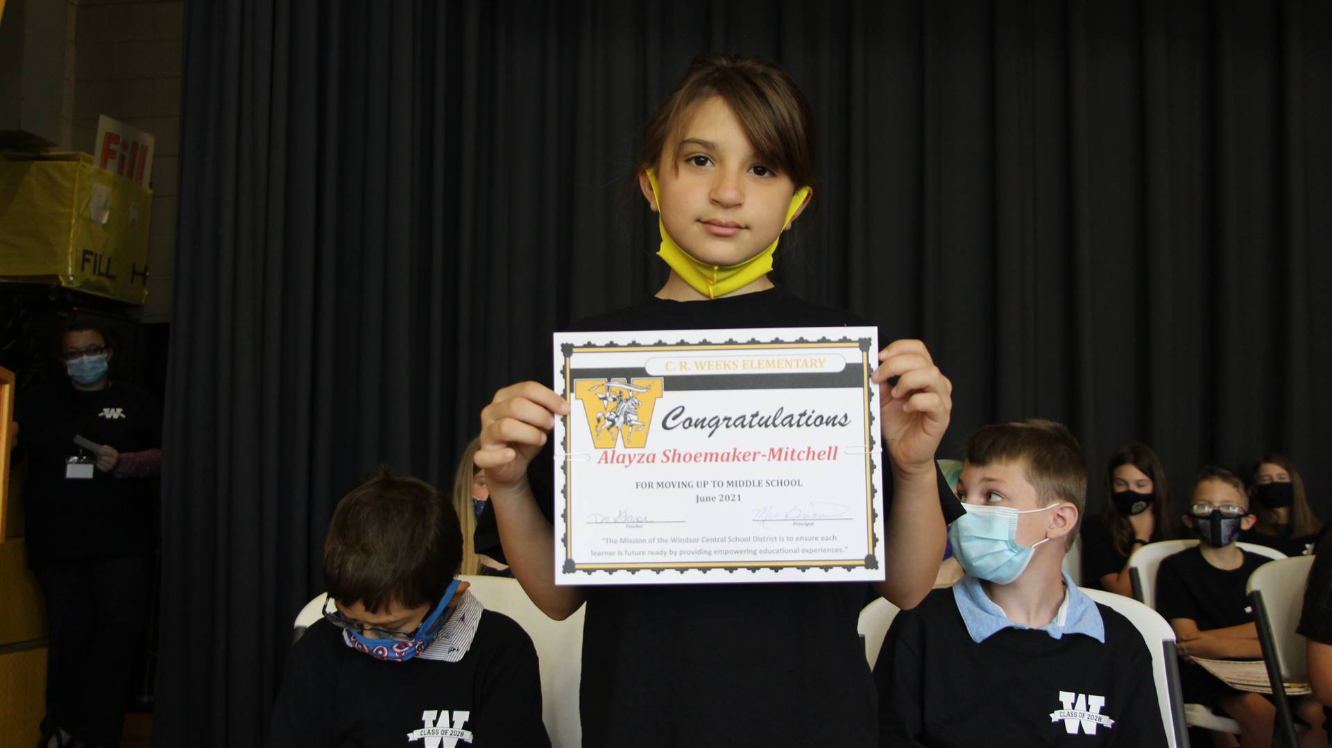 Young boy holding a certificate