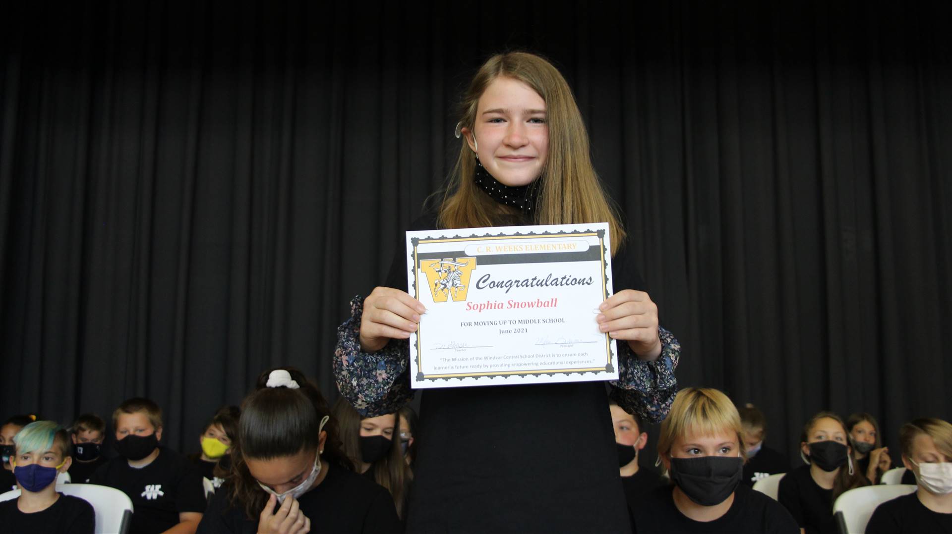 Young girl holding a certificate