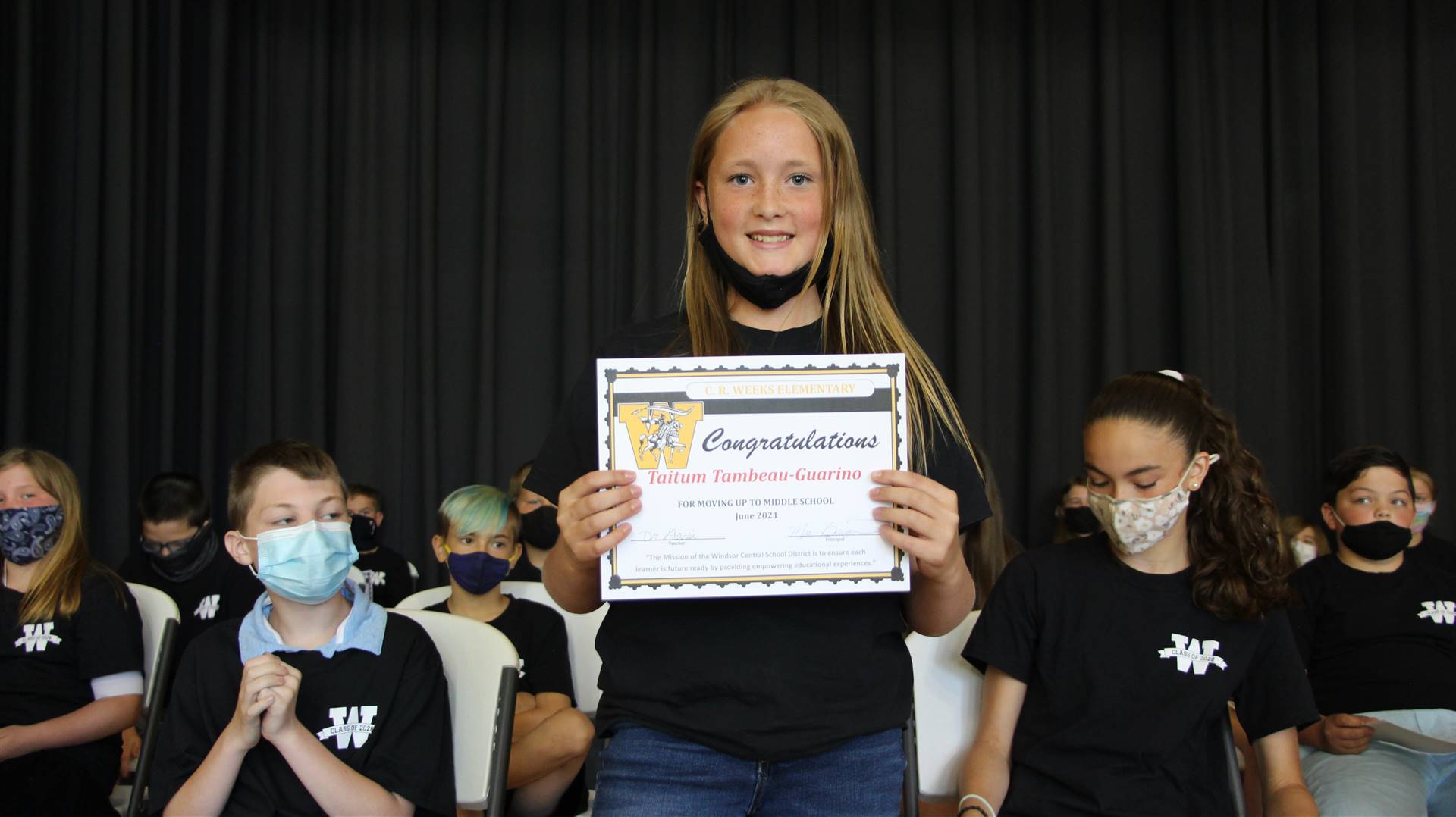 Young girl holding a certificate