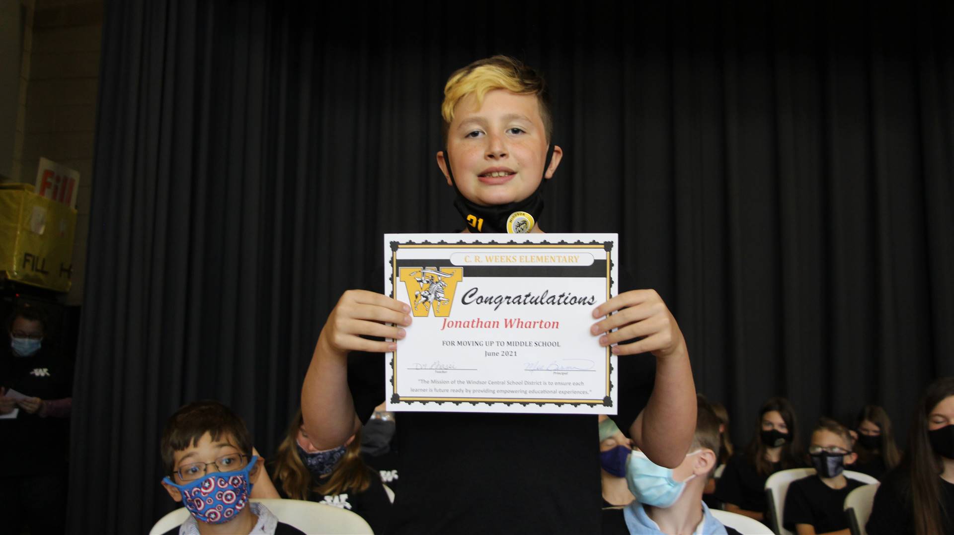 Young boy holding a certificate