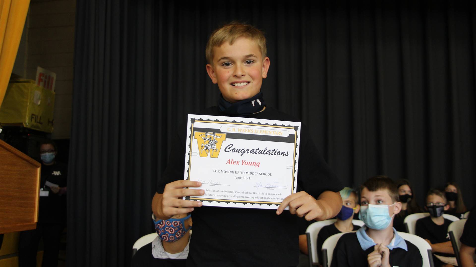 Young boy holding a certificate
