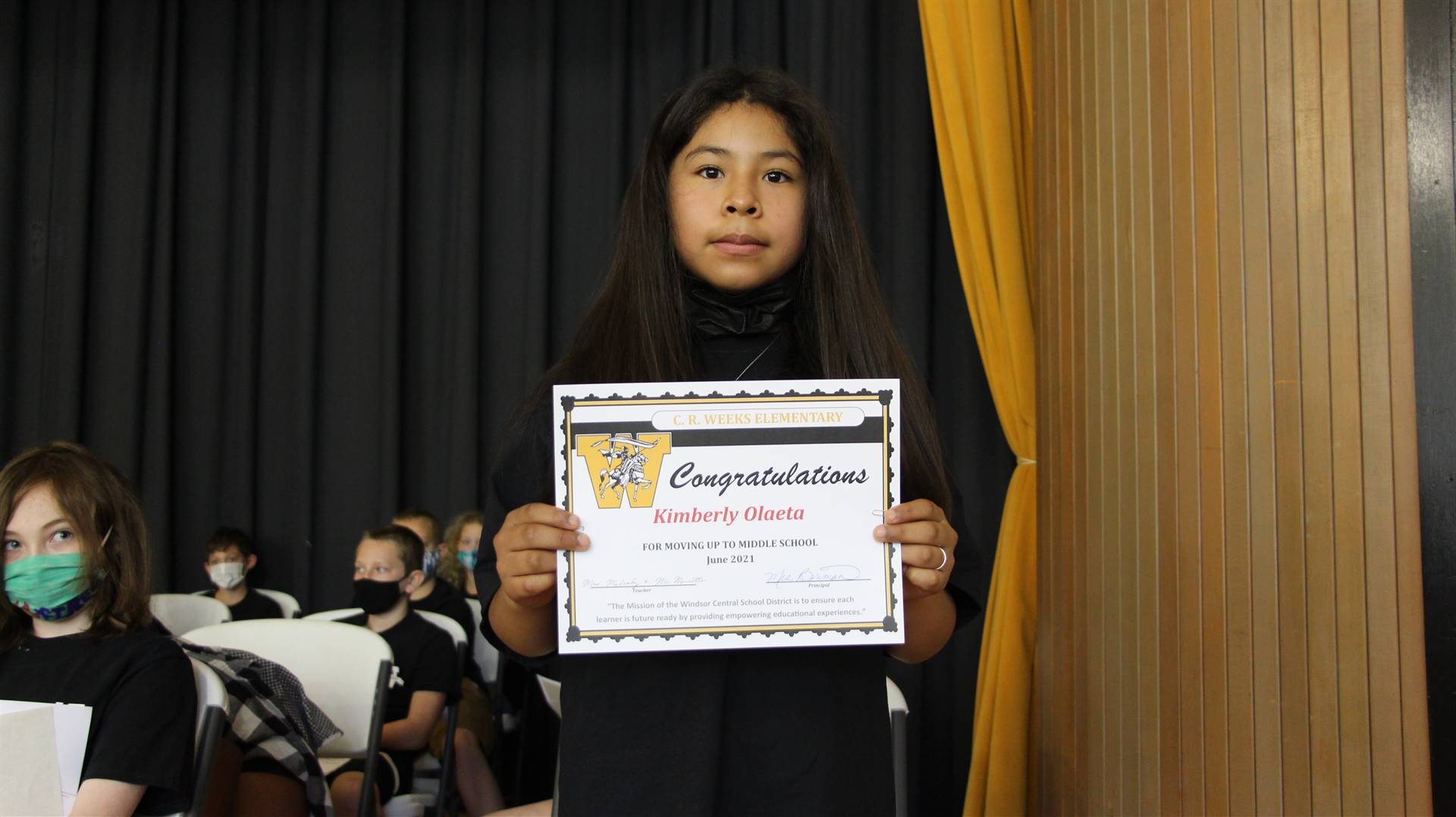 Young girl holding a certificate