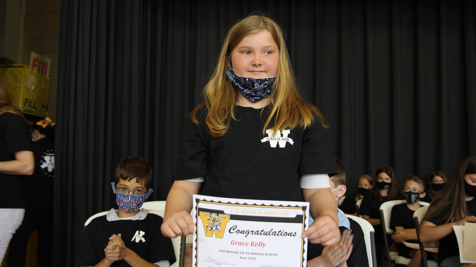 Young girl holding a certificate
