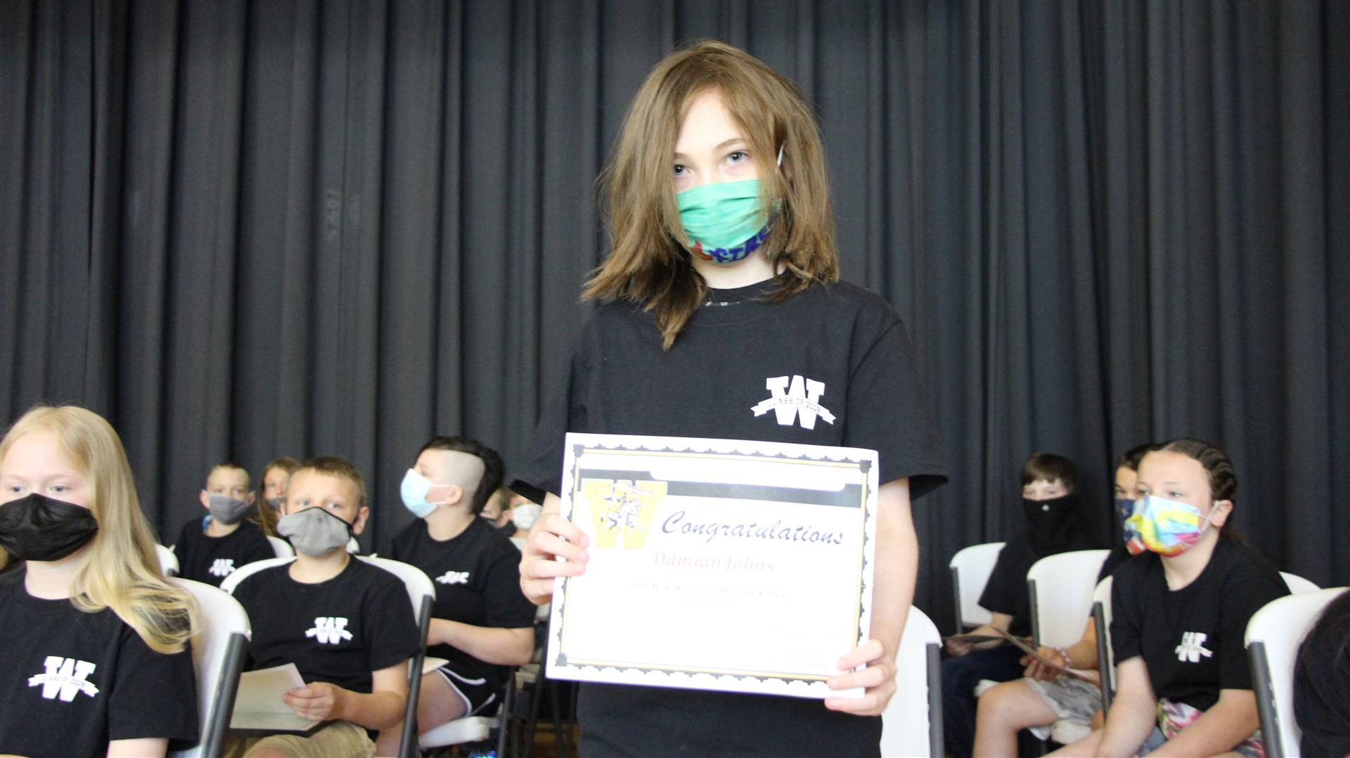Young boy holding a certificate