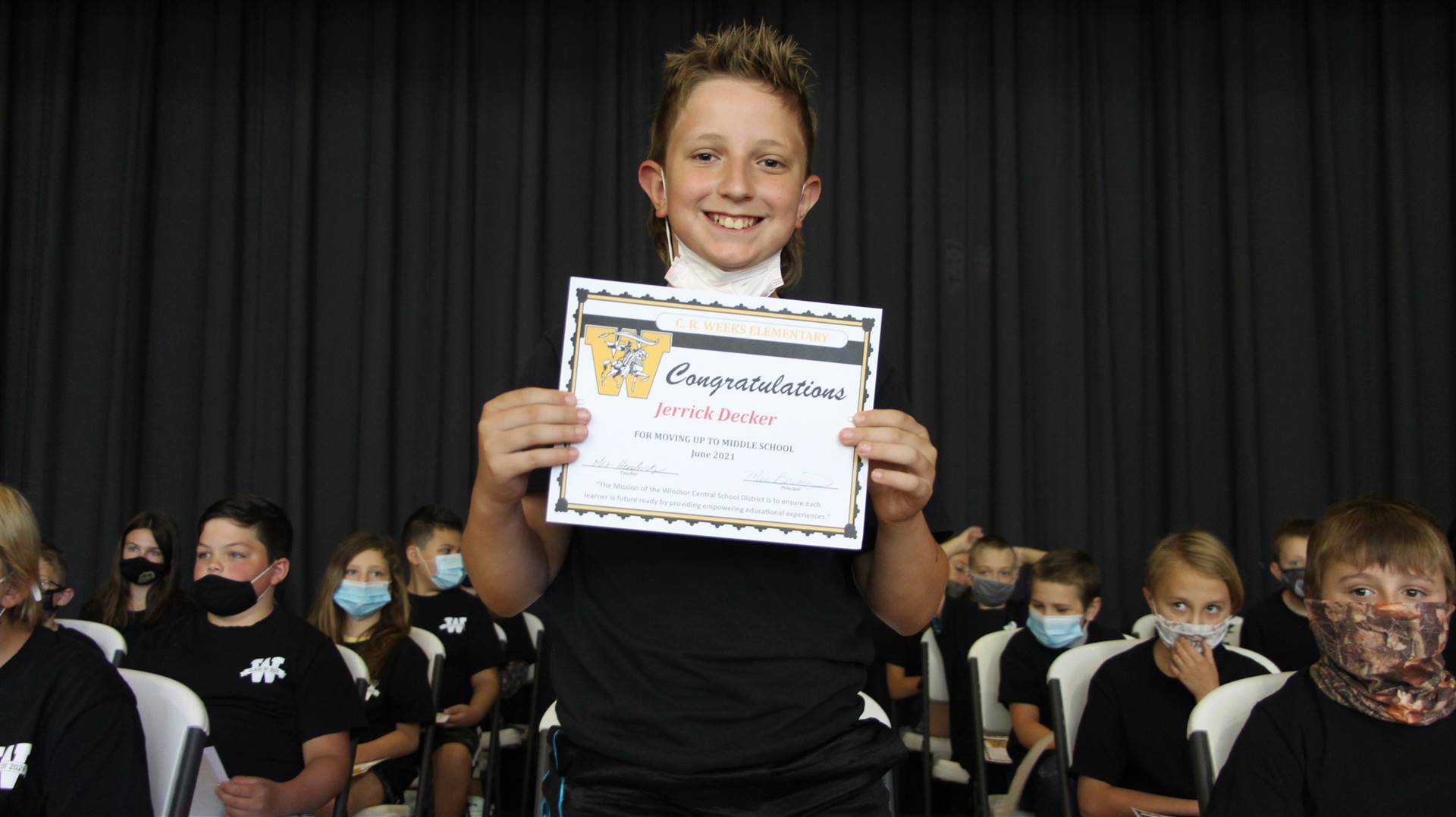Young boy holding a certificate