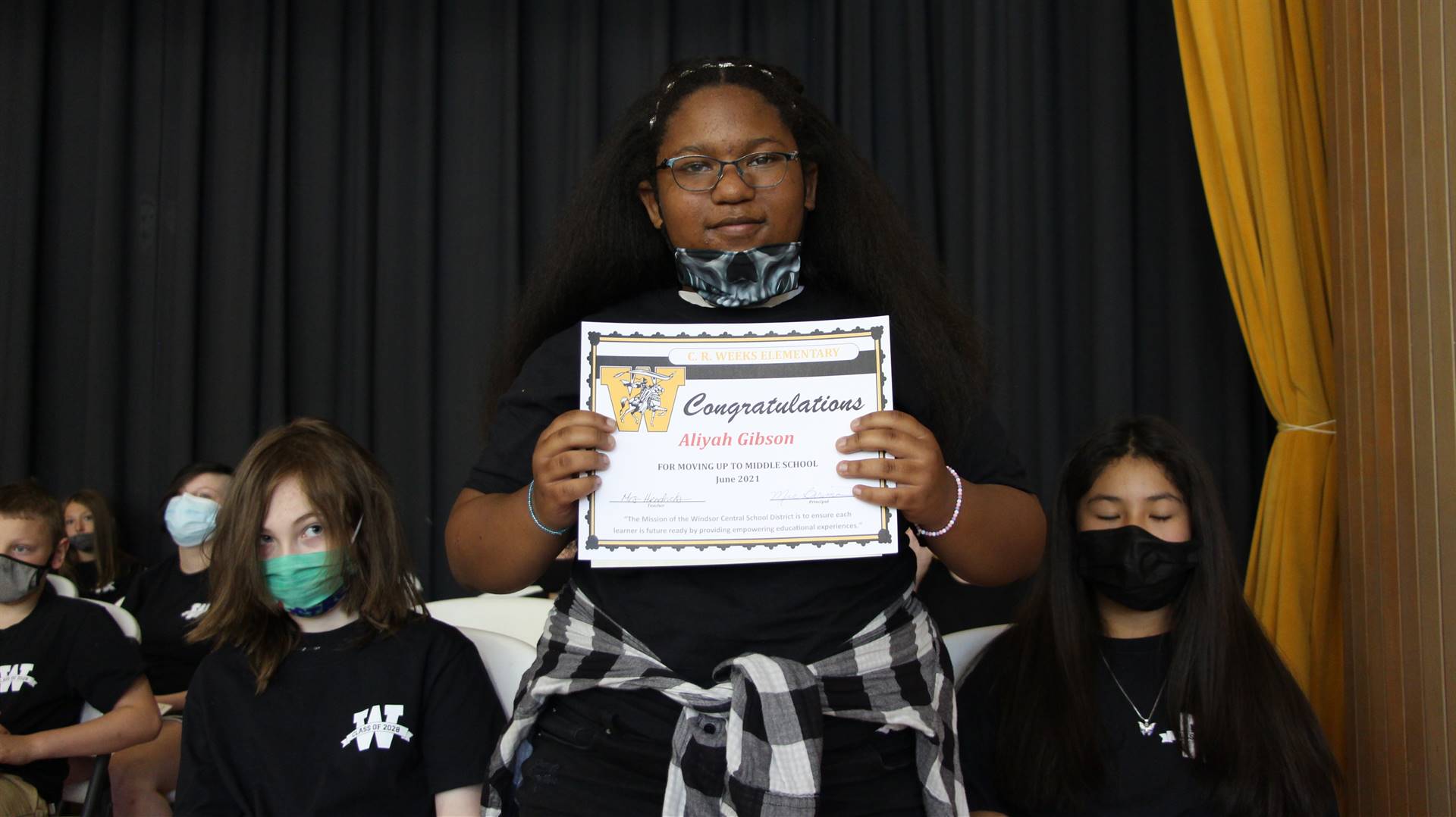 Young girl holding a certificate