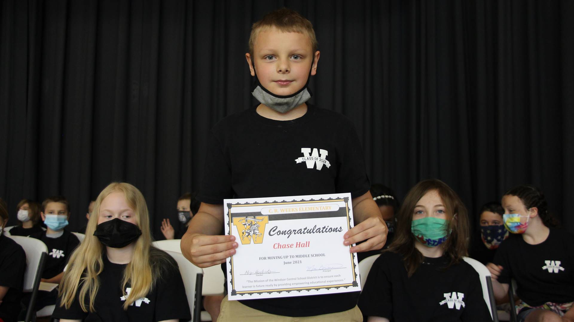 Young boy holding a certificate