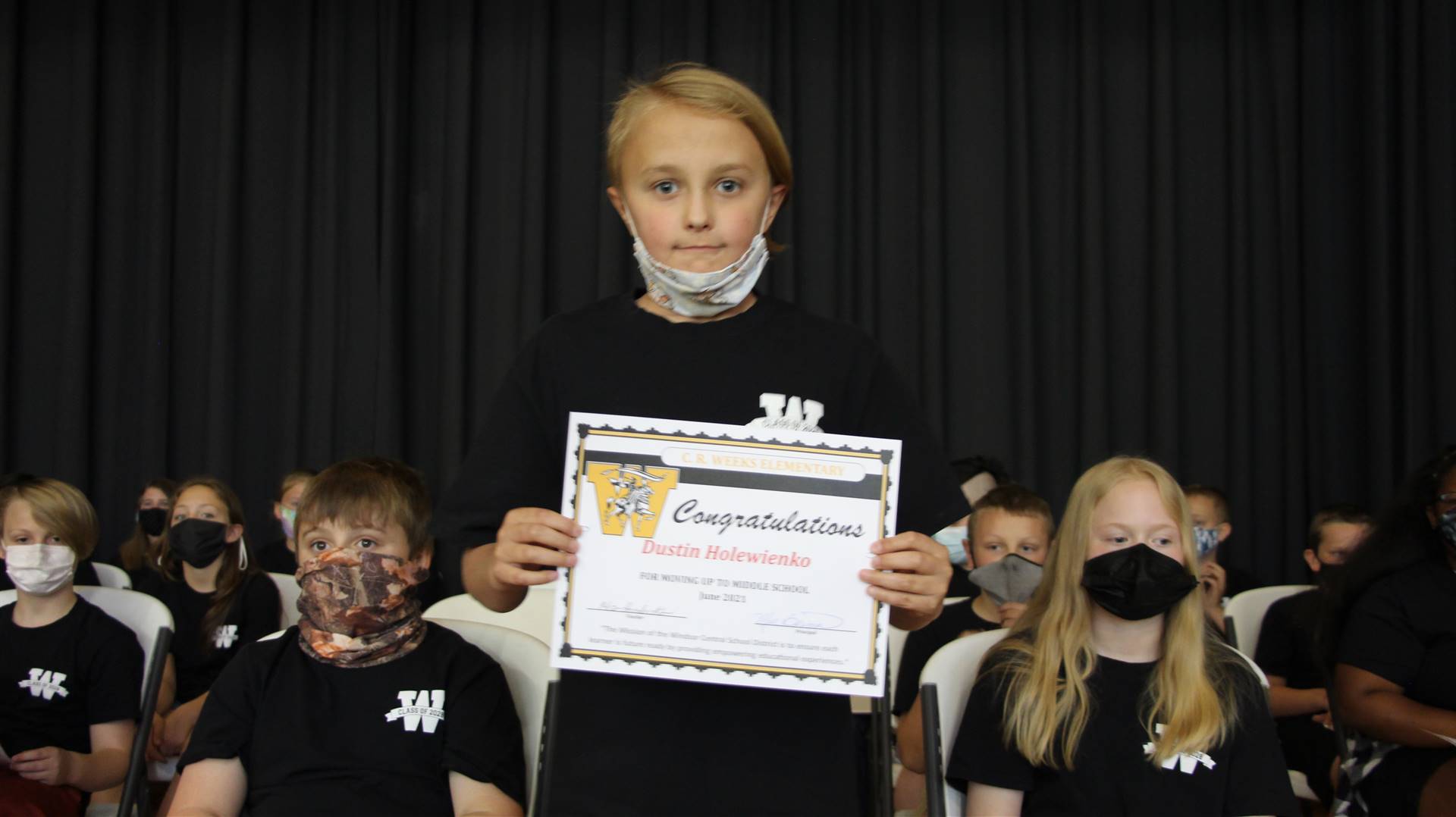Young boy holding a certificate