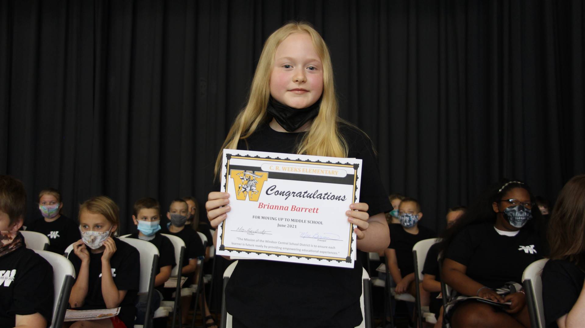 Young girl holding a certificate