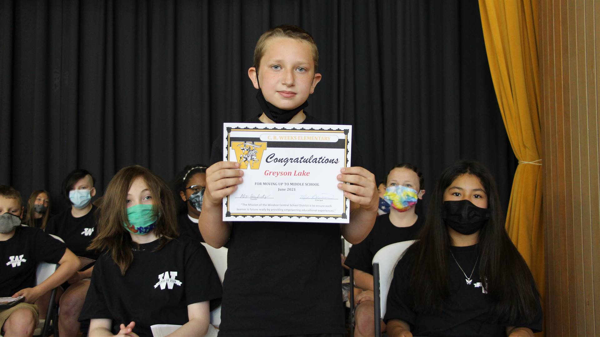 Young boy holding a certificate