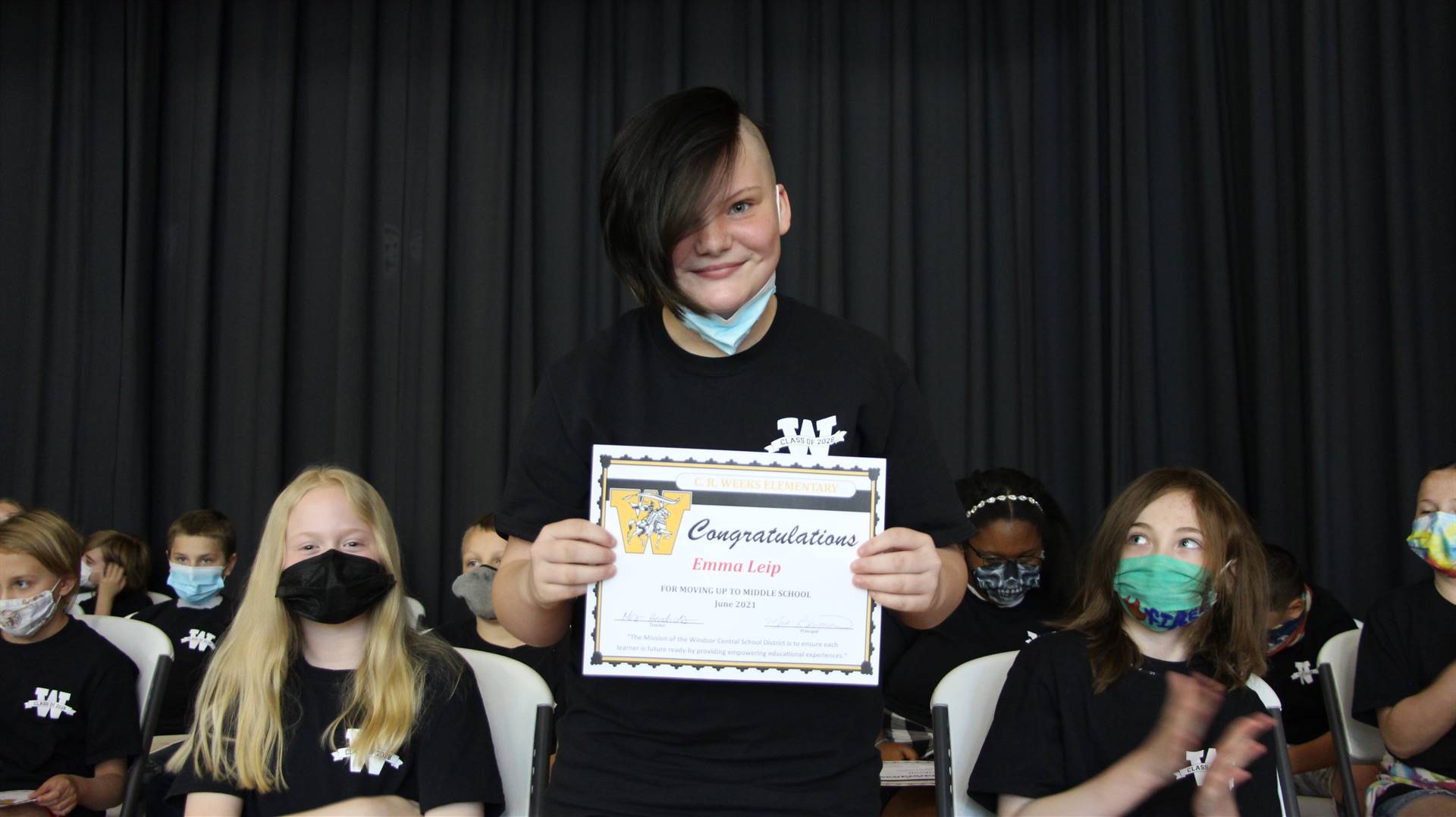 Young boy holding a certificate