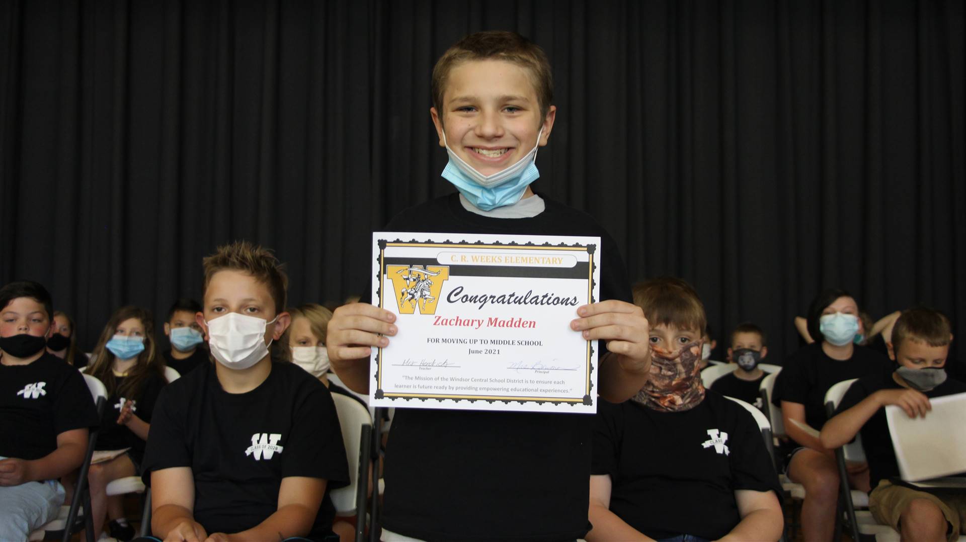 Young boy holding a certificate