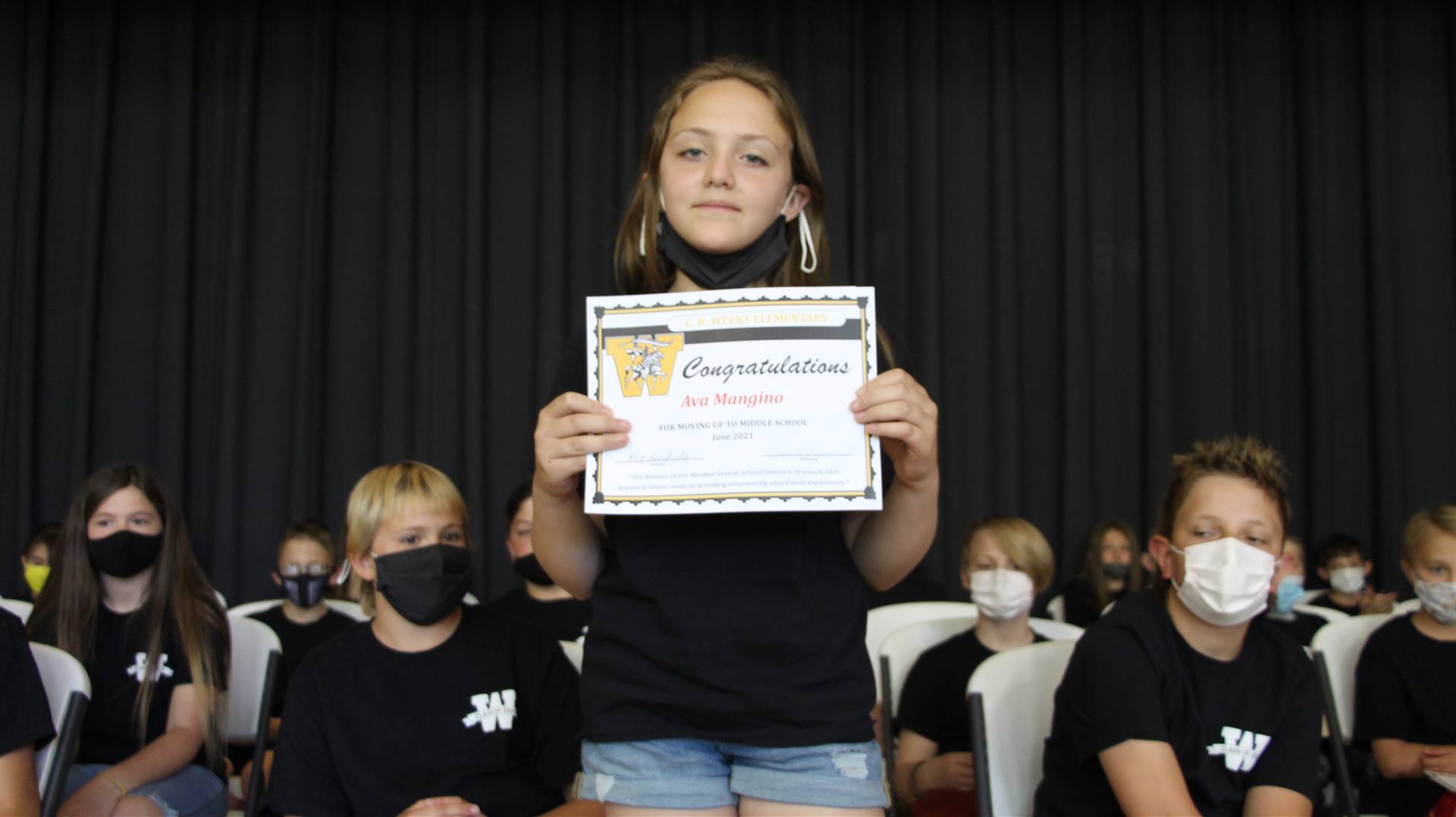 Young girl holding a certificate
