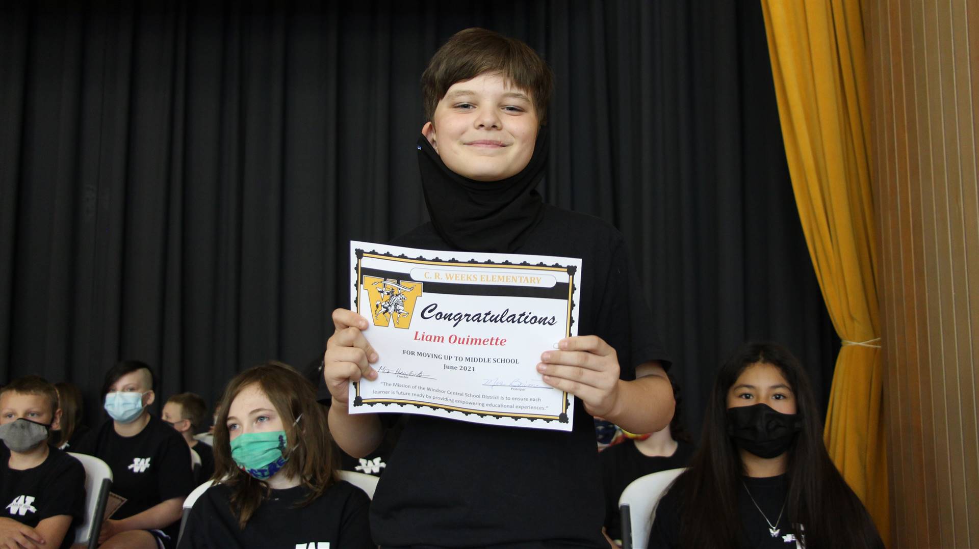 Young boy holding a certificate