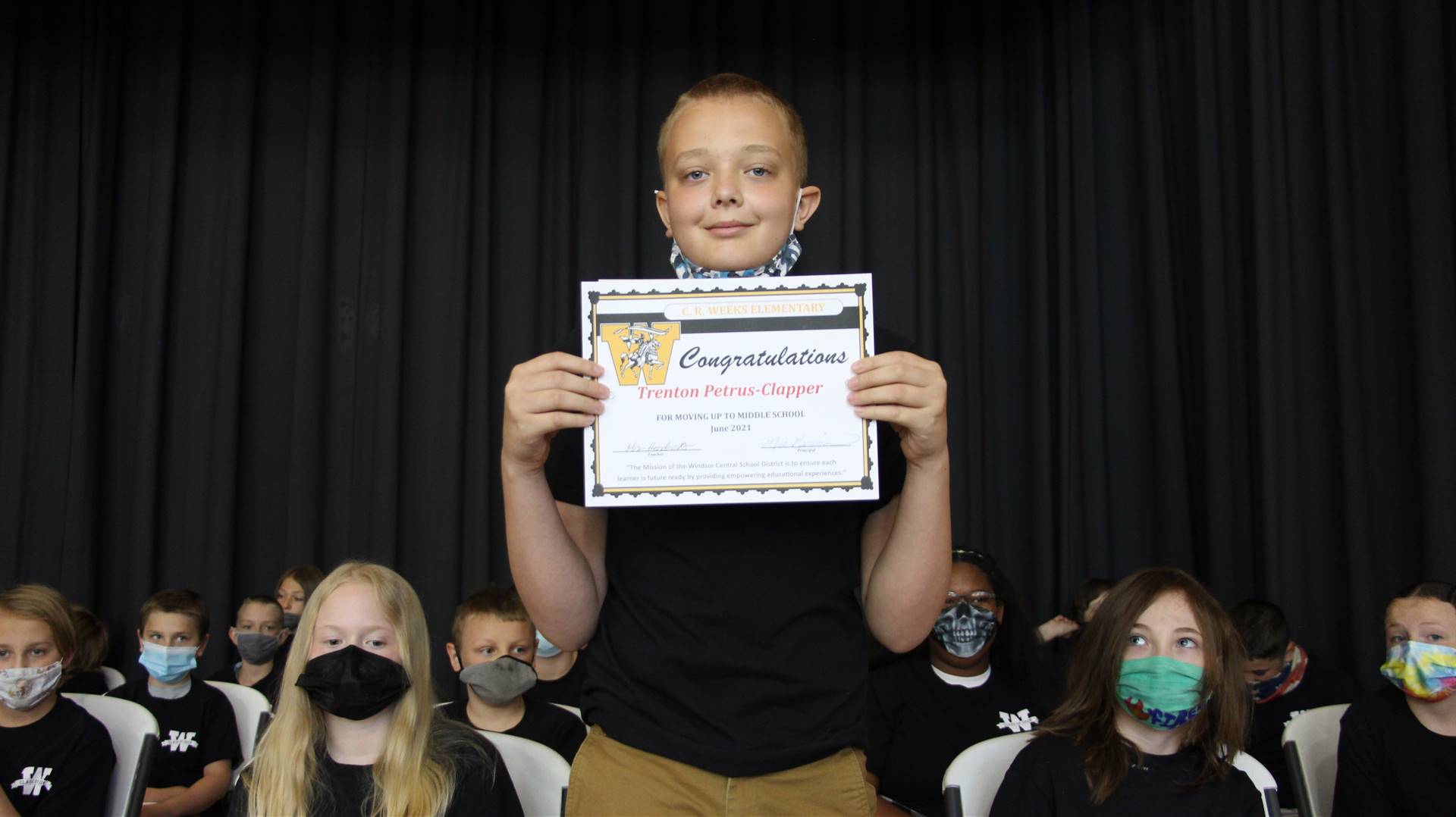 Young boy holding a certificate