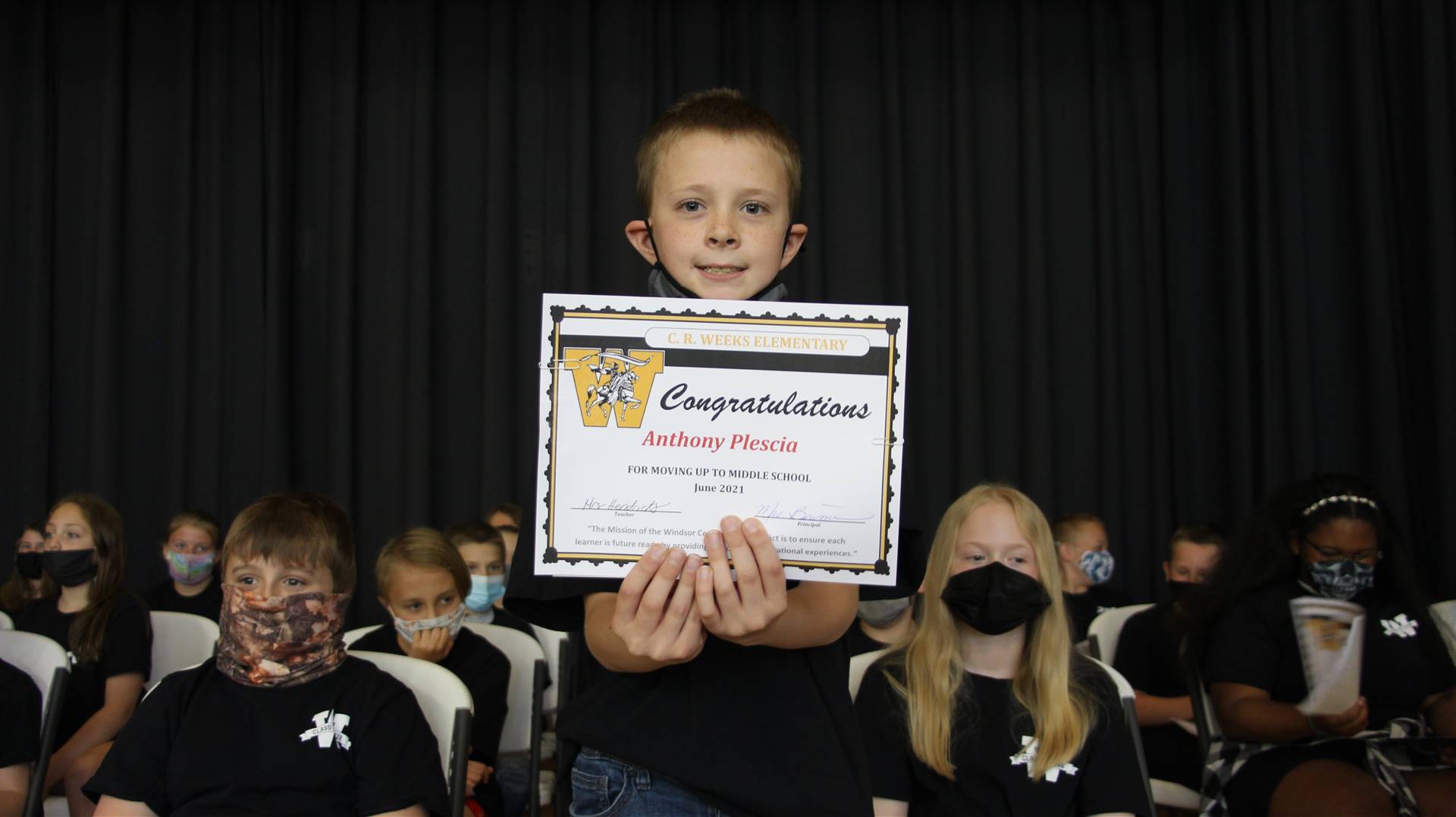Young boy holding a certificate