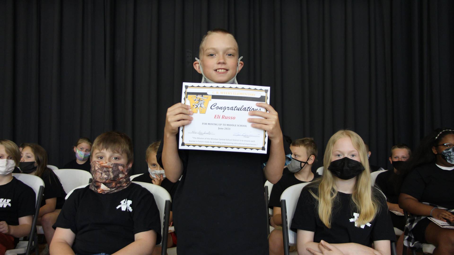 Young boy holding a certificate
