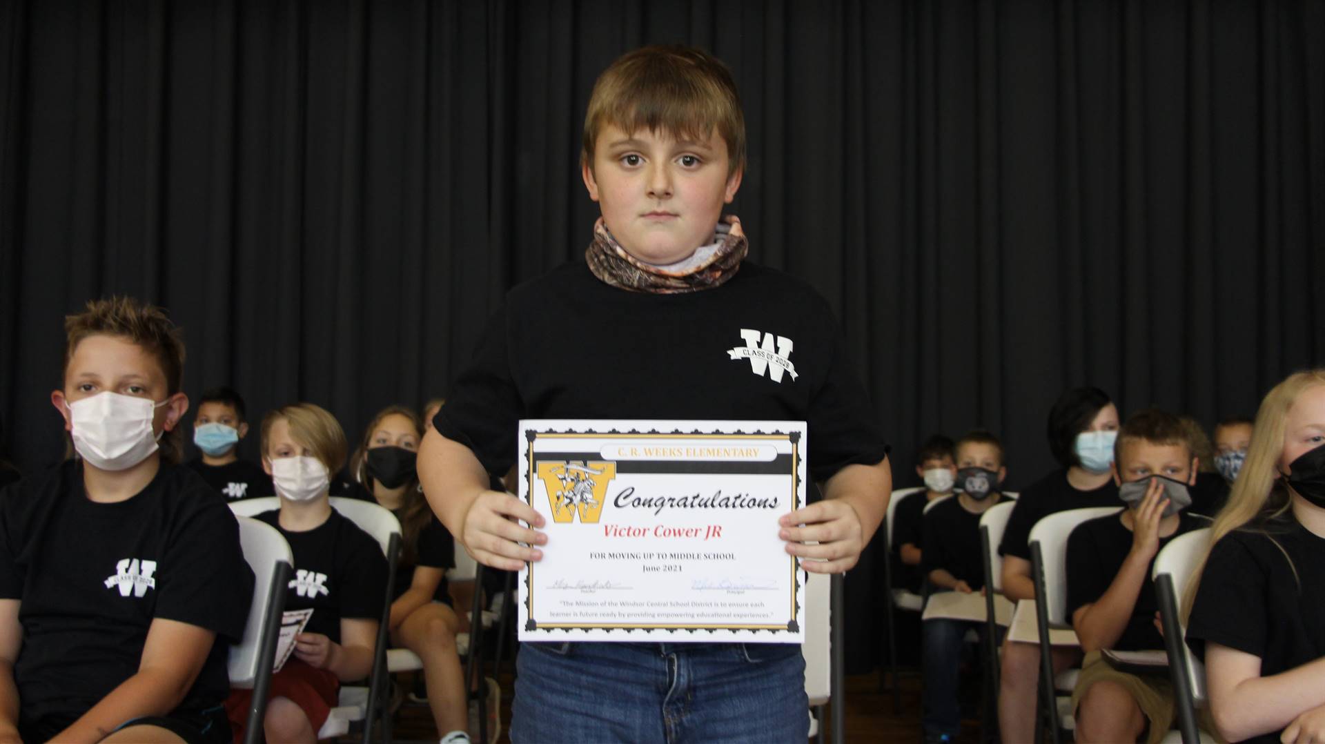Young boy holding a certificate