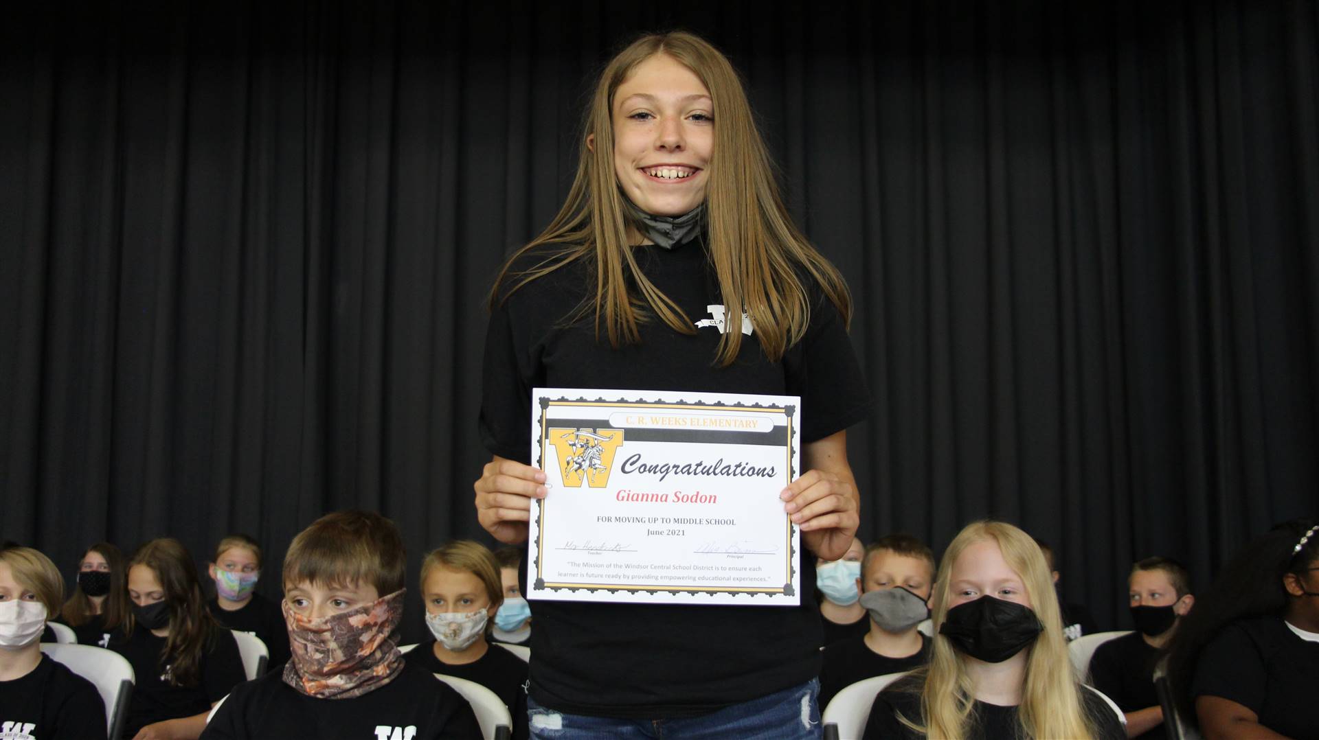 Young girl holding a certificate