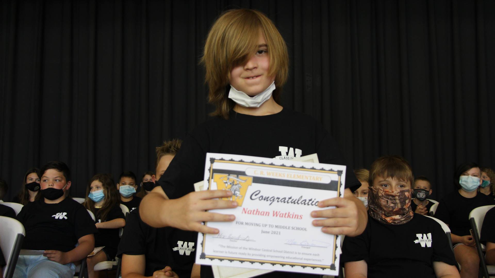 Young boy holding a certificate