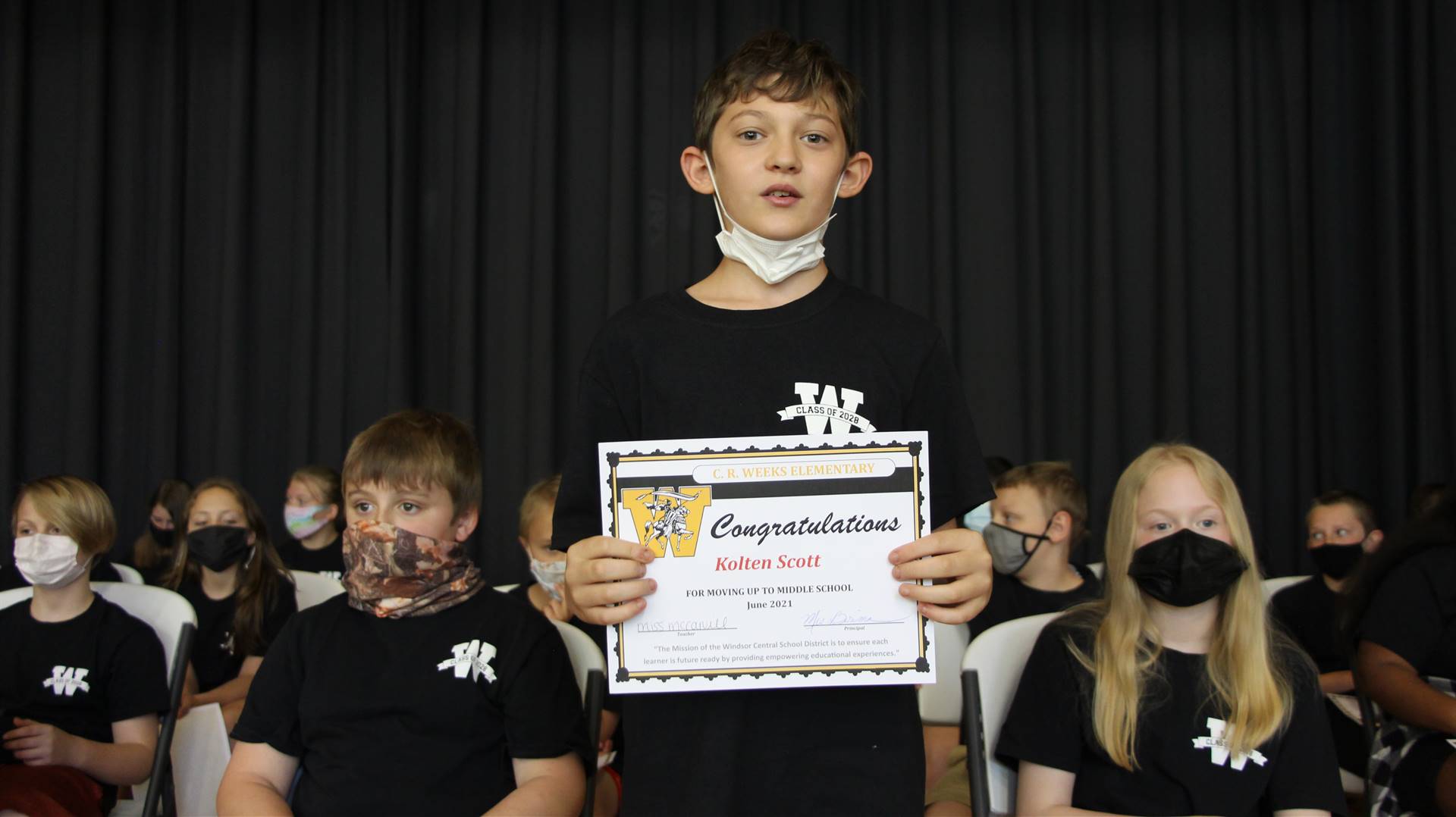 Young boy holding a certificate